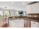 Modern kitchen with stainless steel dishwasher and plenty of counter space overlooking the breakfast nook and living area at 947 Middle Ground Ave, Rolesville, NC 27571