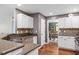 Functional kitchen featuring granite countertops, white cabinetry, and modern appliances, perfect for cooking at 947 Middle Ground Ave, Rolesville, NC 27571