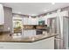 White kitchen cabinets, stainless appliances, eat in bar, and granite countertops at 947 Middle Ground Ave, Rolesville, NC 27571