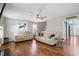 Bright living room with hardwood floors, a ceiling fan, and ample seating, creating a welcoming space at 947 Middle Ground Ave, Rolesville, NC 27571