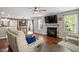 Spacious living room with a fireplace, hardwood floors, and comfortable seating, ideal for relaxation and gatherings at 947 Middle Ground Ave, Rolesville, NC 27571