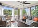 Relaxing screened porch featuring a cozy seating area, rug, and natural light at 947 Middle Ground Ave, Rolesville, NC 27571
