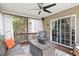 Inviting screened-in porch with comfortable seating, ceiling fan, and view to the backyard at 947 Middle Ground Ave, Rolesville, NC 27571