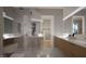 Sleek bathroom featuring modern fixtures, glass shower, dual vanities, and ample storage at 10 Gambel Dr, Youngsville, NC 27596