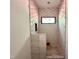 View of bathroom shower with hexagon tile being installed and a small window at 10 Gambel Dr, Youngsville, NC 27596