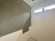 Half-tiled bathroom accent wall with a geometric pattern and natural light from window at 10 Gambel Dr, Youngsville, NC 27596