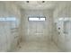 Bright bathroom showcasing elegant white marble tile walls, shower niche and accent lighting at 10 Gambel Dr, Youngsville, NC 27596