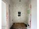 Bathroom in progress with white tiled shower, niche, and visible plumbing at 10 Gambel Dr, Youngsville, NC 27596