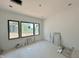 Light filled bedroom with multiple windows, neutral walls and construction materials at 10 Gambel Dr, Youngsville, NC 27596
