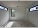 Spacious room featuring ample natural light with three windows showing trees and greenery at 10 Gambel Dr, Youngsville, NC 27596