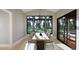 Dining room with large windows, modern table, and chairs, providing a bright and elegant dining experience at 10 Gambel Dr, Youngsville, NC 27596