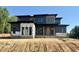 New modern home features clean lines, dark siding and a contemporary design with a bright front door at 10 Gambel Dr, Youngsville, NC 27596