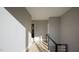 Bright hallway with sleek railings, hardwood floors, and minimalist design at 10 Gambel Dr, Youngsville, NC 27596