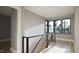 Hallway with modern railings and scenic outdoor views from the windows at 10 Gambel Dr, Youngsville, NC 27596