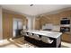Open concept kitchen with a large island, modern appliances, light wood cabinetry and sleek pendant lighting at 10 Gambel Dr, Youngsville, NC 27596
