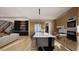 Large kitchen with an island, bar stools, modern appliances, and open layout with living area and staircase at 10 Gambel Dr, Youngsville, NC 27596