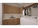 Functional laundry room with ample counter space, modern appliances, and plenty of storage cabinets at 10 Gambel Dr, Youngsville, NC 27596