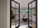 Modern living room with stylish furniture, ample natural light, and view through glass doors at 10 Gambel Dr, Youngsville, NC 27596