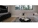 Bright living room with large windows, modern furnishings, and stylish decor create a welcoming atmosphere at 10 Gambel Dr, Youngsville, NC 27596
