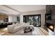 Open-concept living area featuring a modern fireplace, a large sofa, and access to a backyard at 10 Gambel Dr, Youngsville, NC 27596