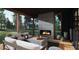 Covered outdoor patio with fireplace, comfortable seating, and serene views of the surrounding landscape at 10 Gambel Dr, Youngsville, NC 27596