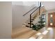 Bright staircase design with wooden steps, black railings, and greenery that accents the space at 10 Gambel Dr, Youngsville, NC 27596