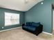 Cozy bedroom with ample natural light from the window and comfortable couch at 102 Forrymast Trl, Apex, NC 27539