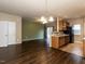 Living space has updated vinyl flooring, neutral paint, and access to the kitchen at 102 Forrymast Trl, Apex, NC 27539