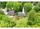 Aerial view of a beautiful home with a private backyard, deck, and lush green surroundings at 102 Pin Oak Ct, Elon, NC 27244