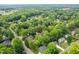 An aerial view showcases the home surrounded by lush greenery in a beautiful residential neighborhood at 102 Pin Oak Ct, Elon, NC 27244
