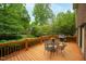 Well-maintained wooden deck with patio furniture and a grill, perfect for outdoor enjoyment at 102 Pin Oak Ct, Elon, NC 27244