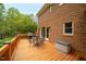 Wooden back deck with patio furniture and a grill overlooking the lush yard at 102 Pin Oak Ct, Elon, NC 27244
