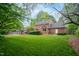 Expansive backyard features lush lawn, mature trees, wooden fence, and charming gazebo at 102 Pin Oak Ct, Elon, NC 27244
