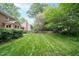 Expansive backyard with lush green lawn and mature landscaping at 102 Pin Oak Ct, Elon, NC 27244