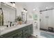 Bright bathroom featuring double vanity, quartz countertop, and modern glass enclosed shower at 102 Pin Oak Ct, Elon, NC 27244