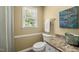 Bright bathroom featuring tile floors, a toilet, vanity, and a motivational art piece at 102 Pin Oak Ct, Elon, NC 27244