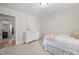Bedroom featuring a comfortable bed, neutral carpet, and a dresser at 102 Pin Oak Ct, Elon, NC 27244