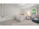 Cozy bedroom featuring a comfortable bed, natural light and a neutral color scheme at 102 Pin Oak Ct, Elon, NC 27244