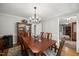 Traditional dining room with a wooden table, chandelier, and classic decor at 102 Pin Oak Ct, Elon, NC 27244