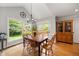 Dining room with access to a deck and backyard and features views of the kitchen area at 102 Pin Oak Ct, Elon, NC 27244