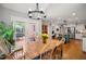Dining room boasts lots of natural light and access to a deck and view of the kitchen at 102 Pin Oak Ct, Elon, NC 27244