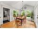 Bright dining area with large windows offering scenic backyard views and natural light at 102 Pin Oak Ct, Elon, NC 27244