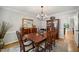 Formal dining room with wooden table, chandelier, and elegant decor for sophisticated gatherings at 102 Pin Oak Ct, Elon, NC 27244