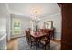 Elegant dining room featuring hardwood floors, large windows, and sophisticated decor at 102 Pin Oak Ct, Elon, NC 27244