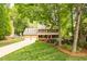 Charming two-story brick home with a manicured lawn, colorful flowerbeds and a two-car garage at 102 Pin Oak Ct, Elon, NC 27244