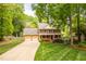 Charming two-story brick home with a manicured lawn, colorful flowerbeds and a two-car garage at 102 Pin Oak Ct, Elon, NC 27244
