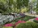 Beautiful landscaped front yard with vibrant azaleas, lush lawn and mature trees at 102 Pin Oak Ct, Elon, NC 27244