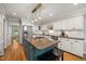 Modern kitchen with granite countertops, stainless appliances, and island cooktop at 102 Pin Oak Ct, Elon, NC 27244