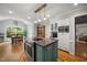 Open kitchen features a kitchen island, modern appliances, and a view of the dining area at 102 Pin Oak Ct, Elon, NC 27244