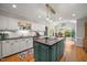 Updated kitchen featuring an island cooktop, stainless appliances, and hardwood floors at 102 Pin Oak Ct, Elon, NC 27244